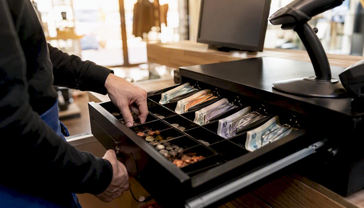 Organized UK cash drawer with notes and coins