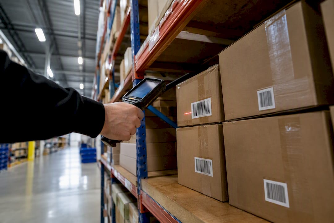 Hand scanning boxes in retail storeroom