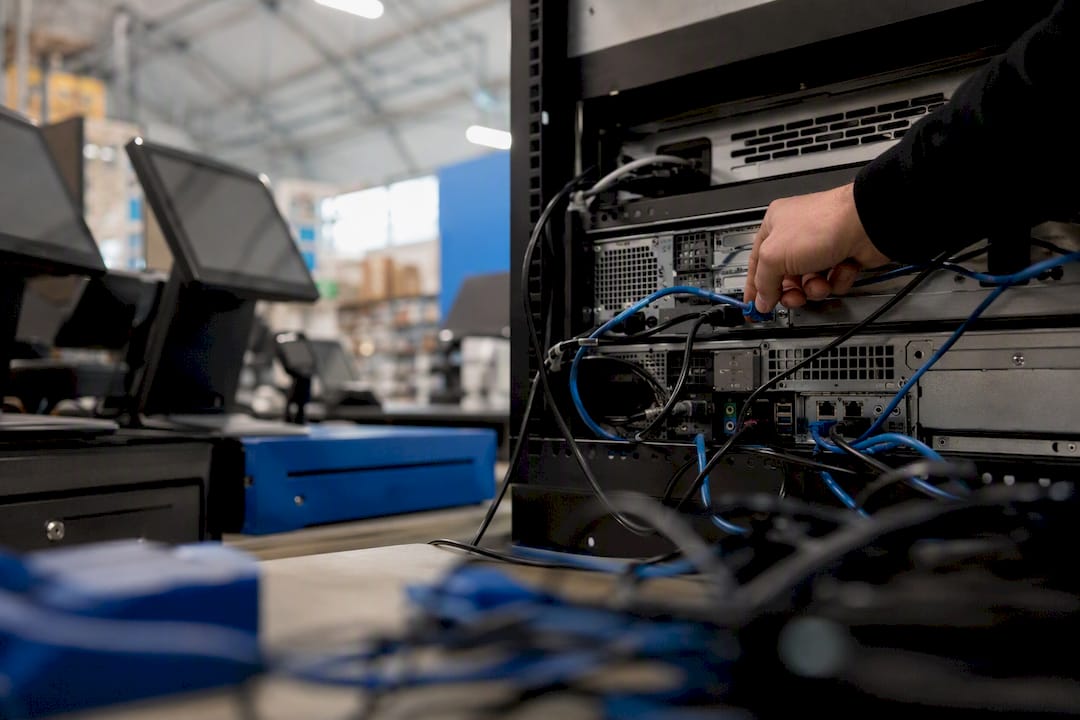 Hands connecting network cable to EPOS hardware