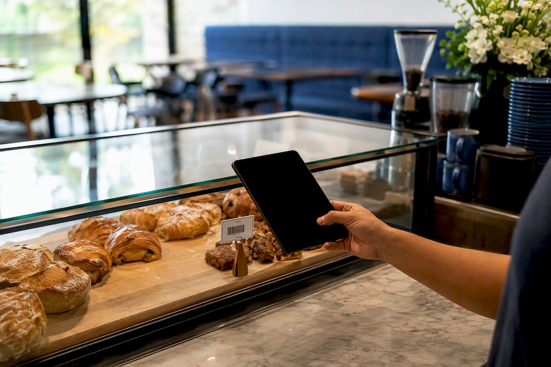 Hand using tablet to scan barcode