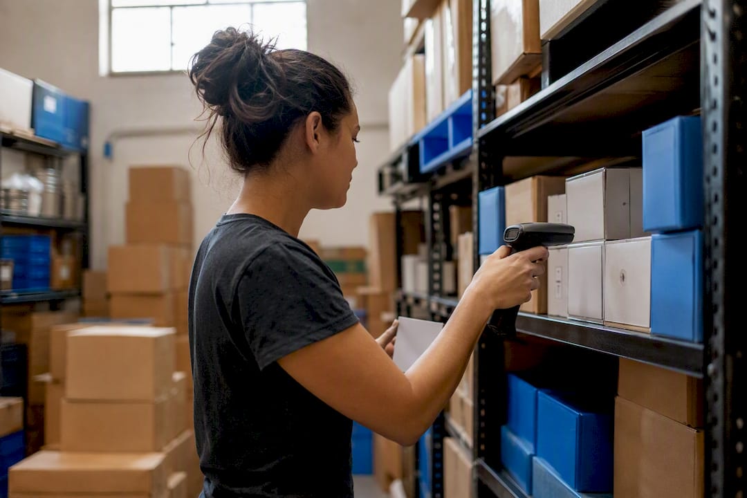 Hands scanning stock in storeroom